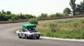 White-colored Porsche 911 drives away over neighborhood HD Footage