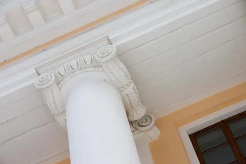 White column on the facade of the building. Architectural detail. Stock Photos