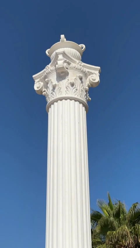 A white column resembling an ancient structure against a clear blue sky, symb Stock Footage 302470522
