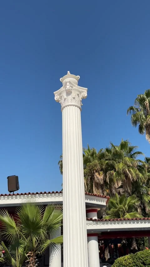 A white column resembling an ancient structure against a clear blue sky, symb Video stock 303358109