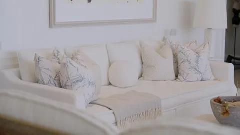 White comfortable sofa with bright and patterned cushions and plaid. Interior Stock Footage 249603208