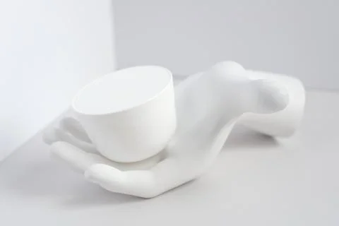 White composition with a jar of cream on the plaster hand in the corner. Conc 库存照片