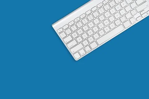 White computer keyboard on sky blue background Stock Photos