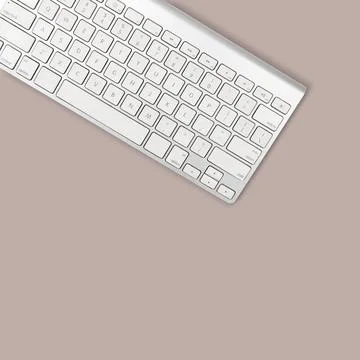 White computer keyboard on sky light brown background Foto stock