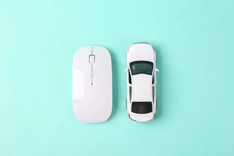 White computer mouse and toy car on blue background 스톡 사진