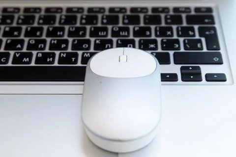 White computer mouse on the keyboard. Place for logo and text. Stock Photos