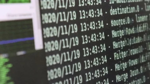 White computer software code moving on a black monitor reflect on glass defoc Stock Footage 144125379