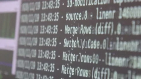 White computer software code moving on a black monitor reflect on glass defoc Stock Footage 144125549