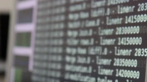 White computer software code moving on a black monitor reflect on glass defoc Stock Footage 144125878