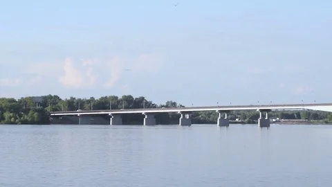 White concrete beam bridge over a wide river in the city Stock Footage 77576337