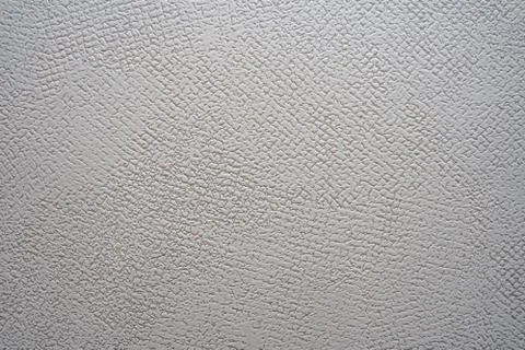 White concrete surface with small pits. Grey wall with copy space. Stock Photos