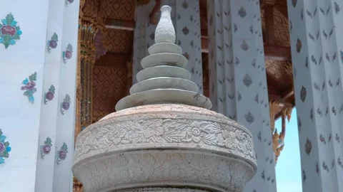 A white conical multi-leveled white stone Stupa with stone carved floral pattern Stock Footage 308896495