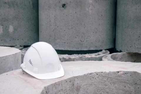 White construction helmet on concrete background. Personal protection for a w Stock Photos