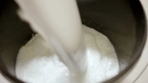 White construction mixture is poured into a bucket Stock Footage 163295070