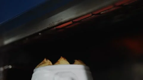 A white container with three pastries inside of it Stock Footage 295994939