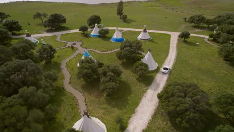 White convertible drive offroad on the background of wigwams Stock Footage 260220592