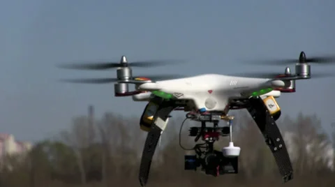 White Copter\drone  with camera slow  fly  away Stockbeeldmateriaal 37309300