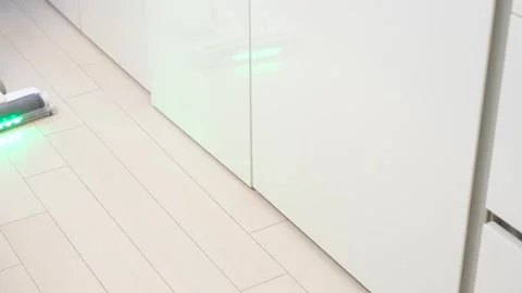 White cordless vacuum cleaner on laminate flooring close-up. Stock Footage 330043182