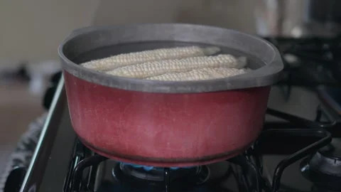 White corn boiling in a red pot on a gas stove Stock-Footage 330087459