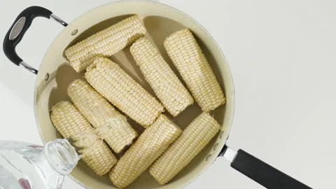 White corn. Boiling sweet white corn close up on white background Stock Footage 132782137