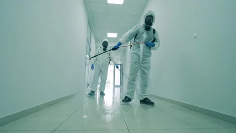 White corridor is getting chemically sanitized by the specialists Stock Footage 130623977