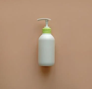 White corrugated bottle surface soap dispenser pump. Skin care Lotion. Stock Photos