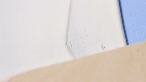 White cosmetic texture, foam, face cream close-up on a blue background. Stock Footage 231768176