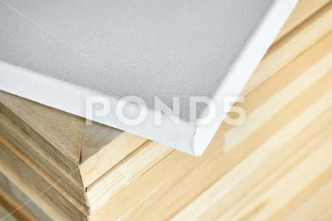 White cotton canvas. Wooden stretchers in the background. Selective focus Stock Photos