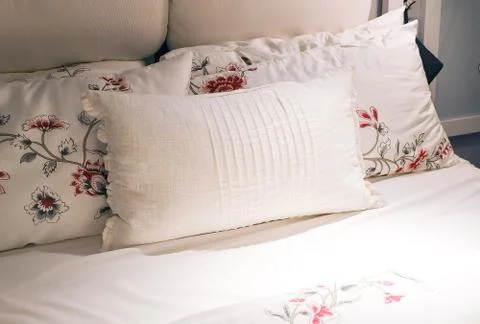 White Cozy Bed with Five Comfortable Soft Vintage Pillows. Stock Photos
