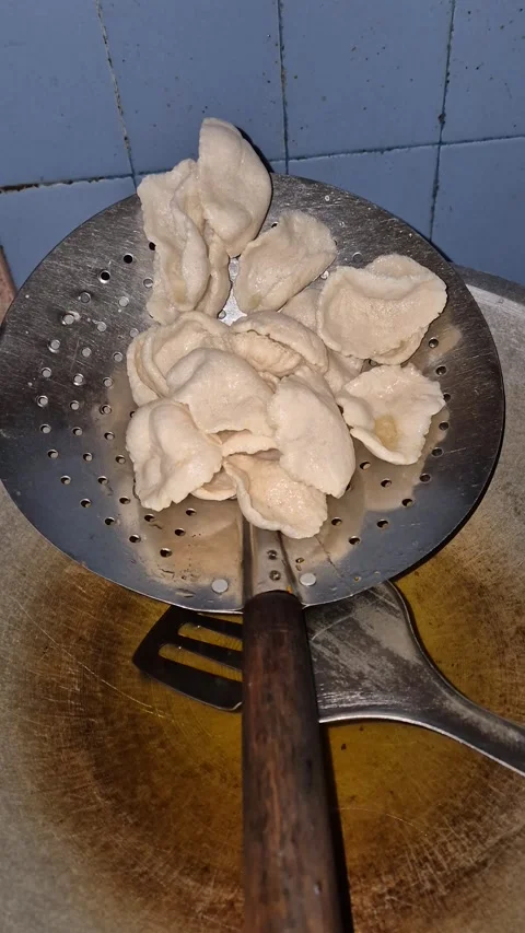 White crackers draining on a metal strainer Stock Footage 336815503
