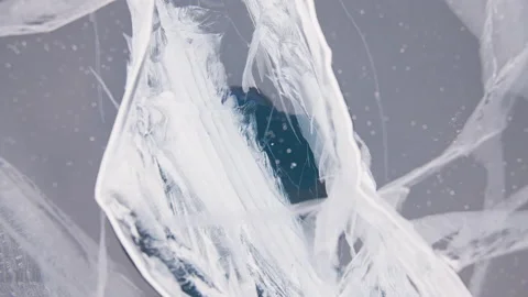 White cracks inside crystalline clear ice texture. Macro, zooming out. Stock Footage 165146515
