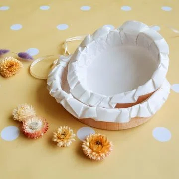 White craft plates in spring decor. Flowers, festive atmosphere, holiday. E.. Stock Photos