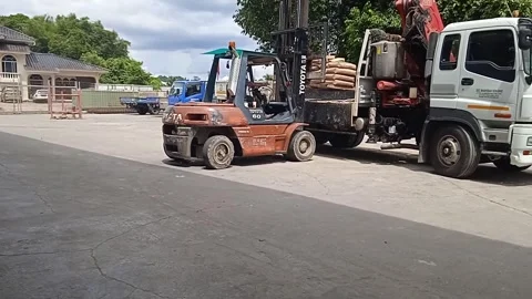 White Crane Truck Loading Cement Assisted by Forklift Stock Footage 309306751