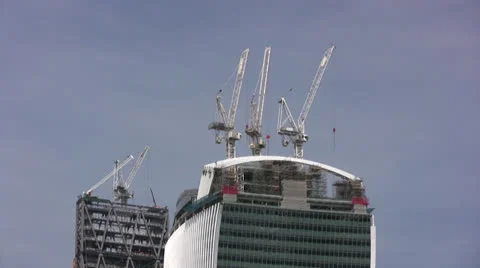 White cranes on top of large building extreme long shot Stock-Footage 25927477