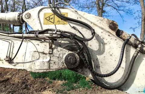 White crawler excavator working at a construction site for pipe installation. Stock-Fotos