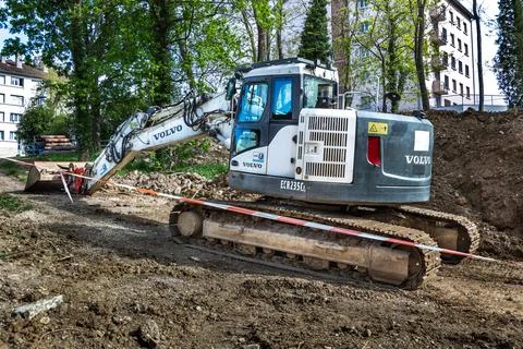 White crawler excavator working at a construction site for pipe installation. 写真素材