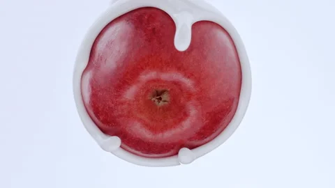 White cream enveloping an apple Stock Footage 219464336