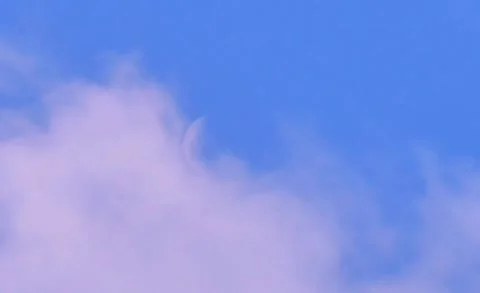A white crescent or half moon in a blue sky. 스톡 동영상 319418521