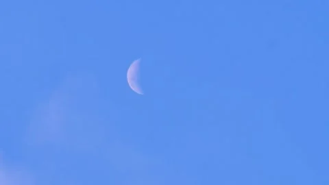 A white crescent or half moon in a blue sky. Stock Footage 319418594