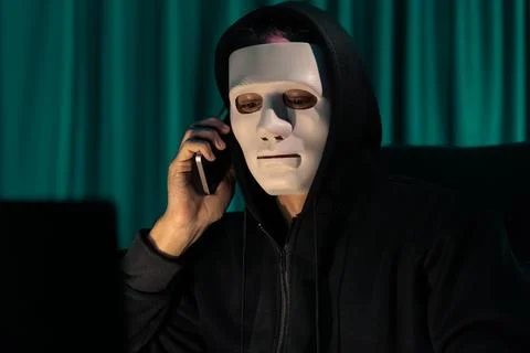 White criminal anonymous mask calling to IT owner to threaten ransom. Pecuniary. 스톡 사진