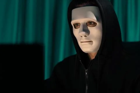 White criminal anonymous mask installing coding password encryption. Pecuniary. Stock-Fotos