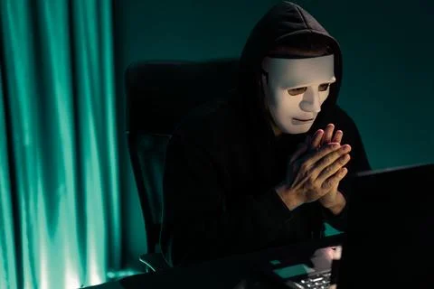 White criminal anonymous mask installing coding password encryption. Pecuniary. Stock-Fotos