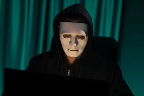 White criminal anonymous mask installing coding password encryption. Pecuniary. Stock Photos