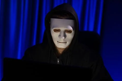White criminal anonymous mask installing coding password encryption. Pecuniary. Stock Photos
