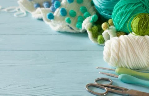 White crocheted fabric with color patterns. Bright aquamarine, blue and green 스톡 사진