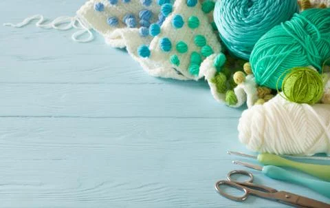 White crocheted fabric with color patterns. Bright aquamarine, blue and green 스톡 사진