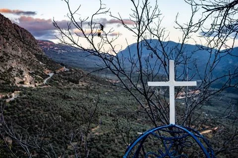 White cross is elegantly positioned overlooking Delphi Delfos valley. Greece Stock Photos