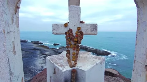White cross with flowers on the hill at the ocean coast Stock Footage 59794251