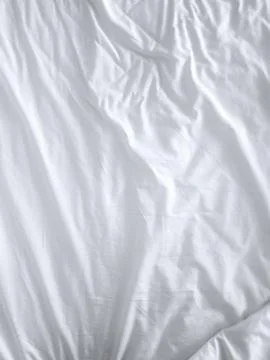 White crumpled fabric texture background. Stock Photos