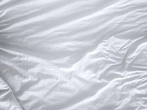 White crumpled fabric texture background. Stock Photos